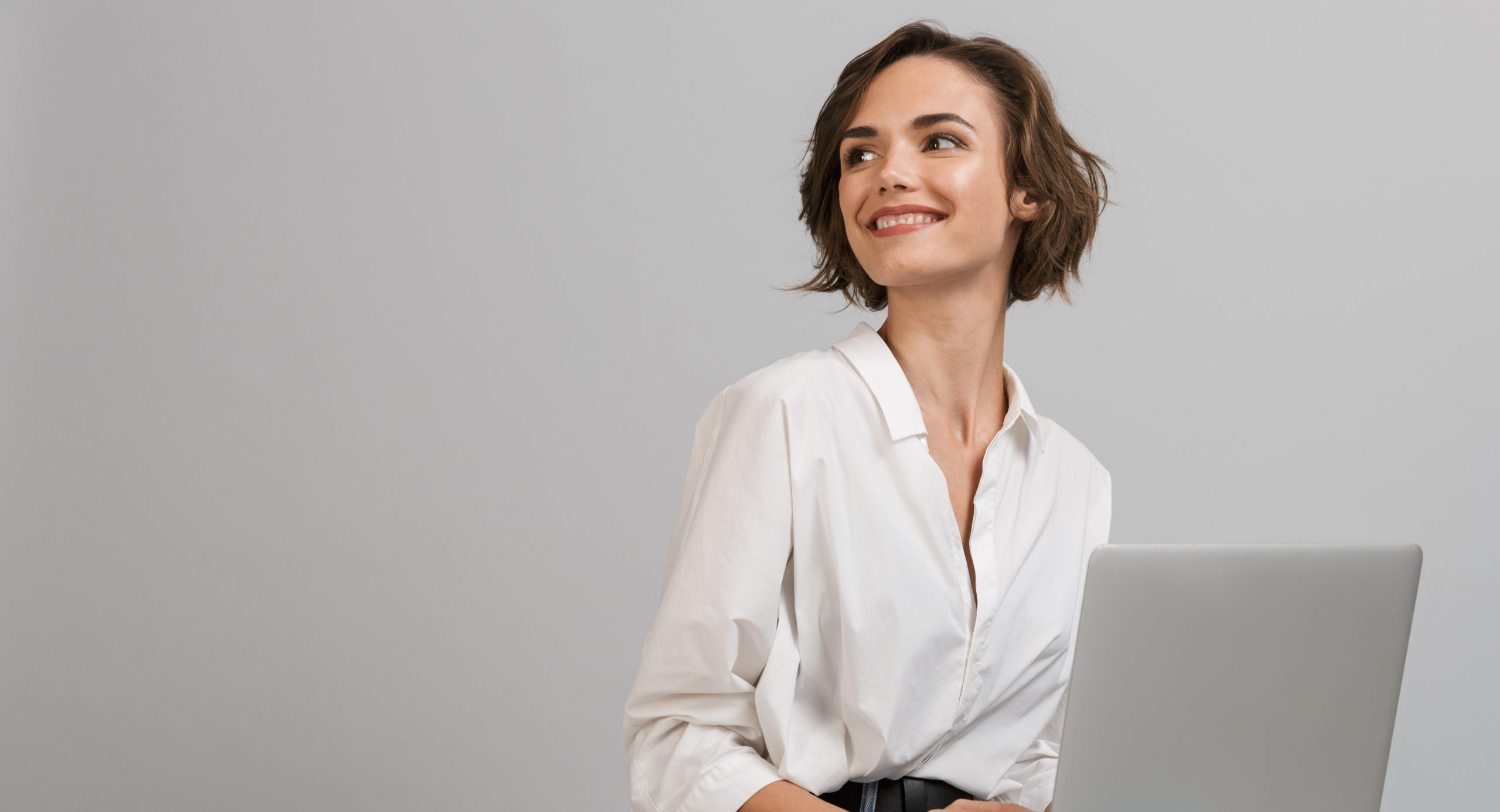 female benefits recruiter on laptop smiling
