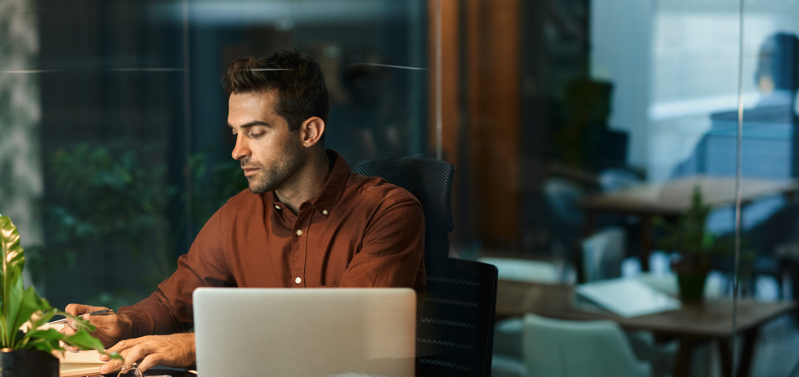 male benefits recruitment firm professional working late on laptop