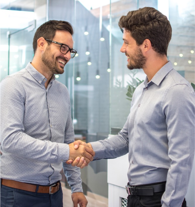 job seeker shaking hands with person from sales staffing company