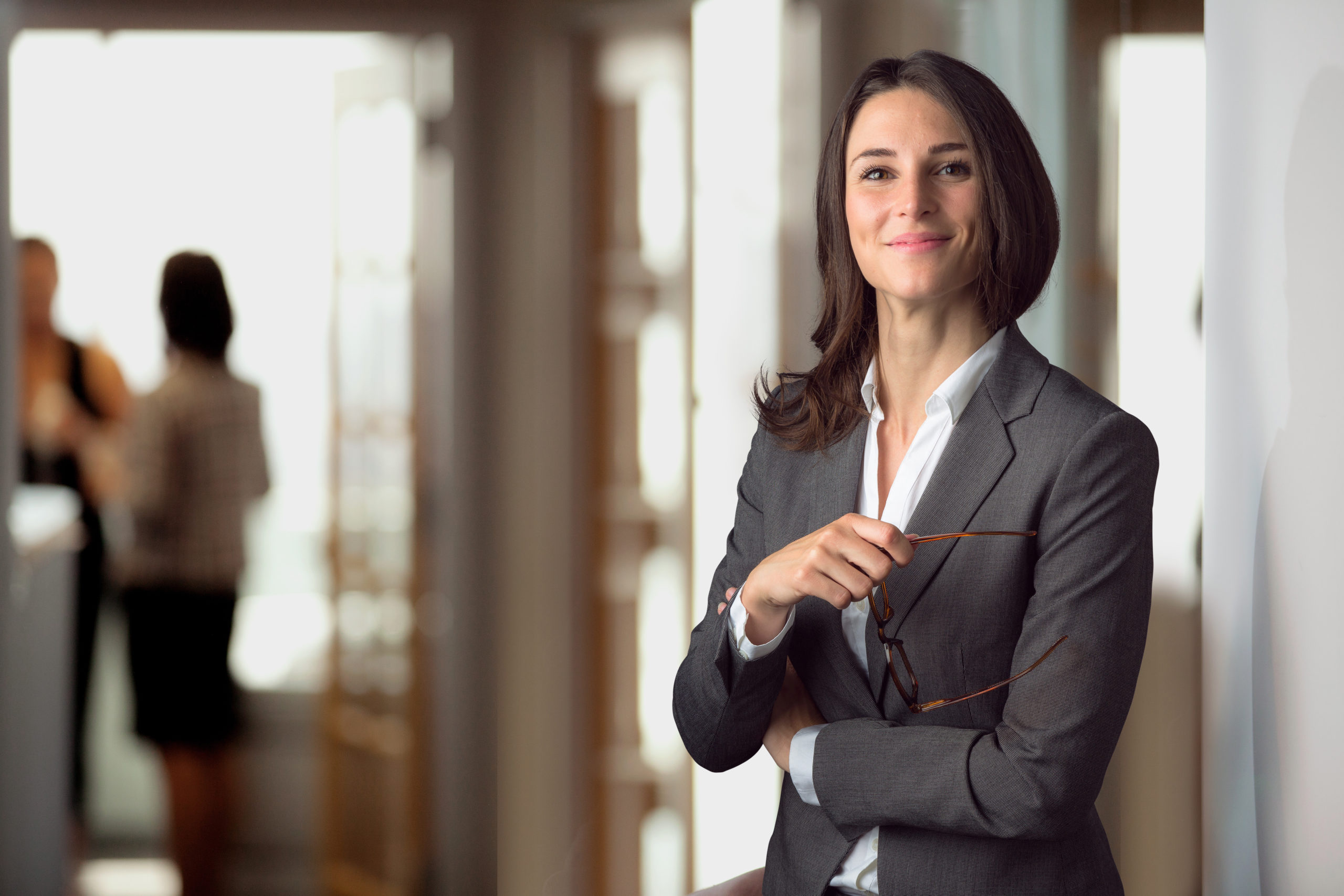 female audit recruiter standing in office in suit