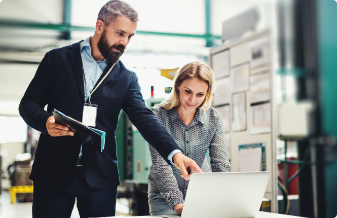 male and female manufacturing engineers - Search Solution Group manufacturing engineers looking at latop