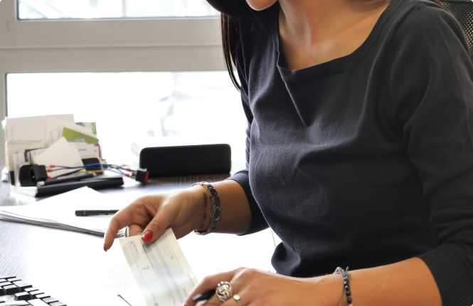 payroll recruitment firm professional writing checks - Search Solution Group female payroll specialist writing checks