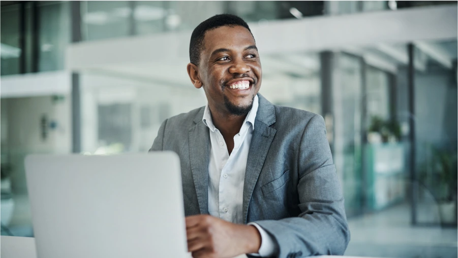 technical sales recruiter smiling while working on a laptop