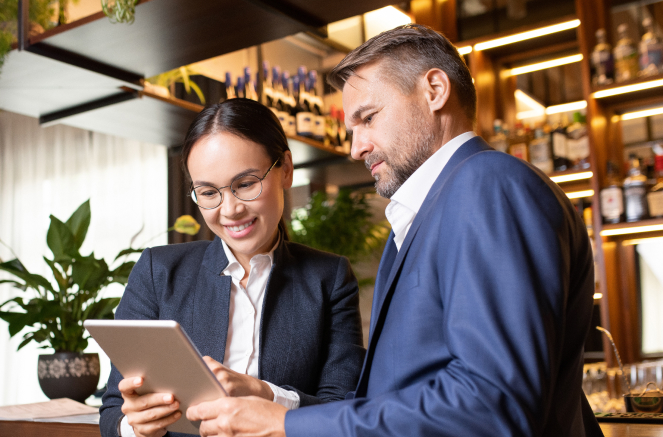 food and beverage recruiters discussing a report on a tablet