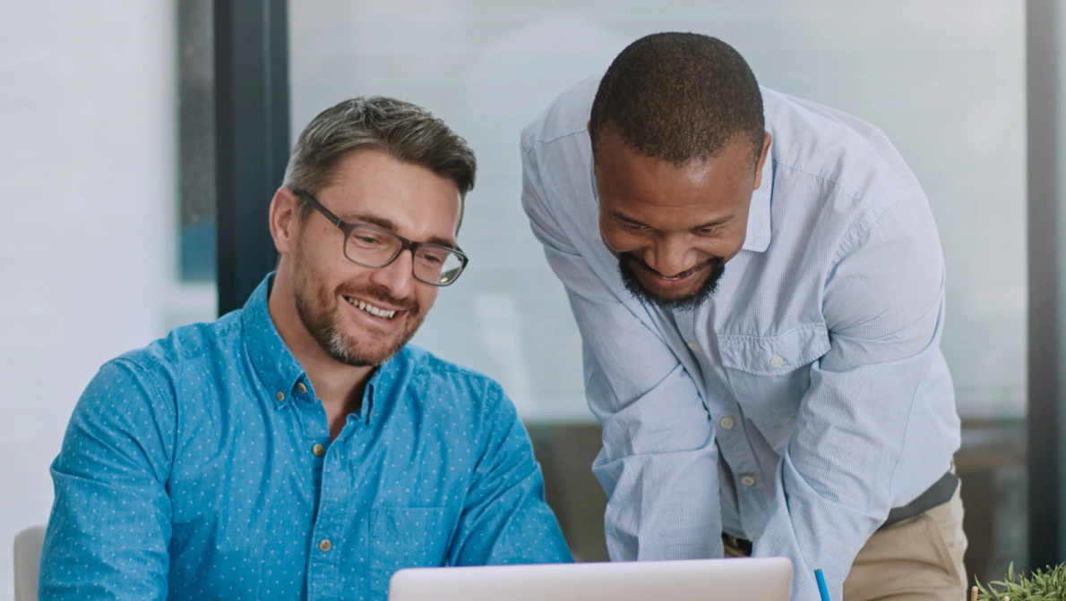 outside sales recruiter meets candidate and looks on laptop