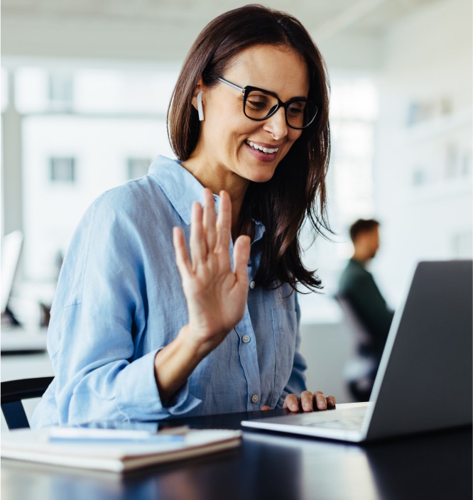 technical sales recruiter waving on a virtual meeting on a laptop