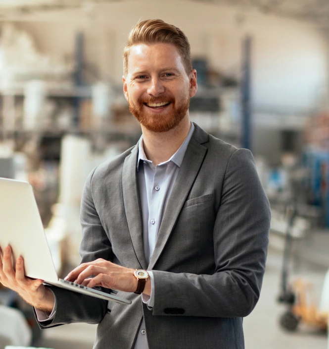 plant management candidate smiling plant management headhunter smiling holding laptop