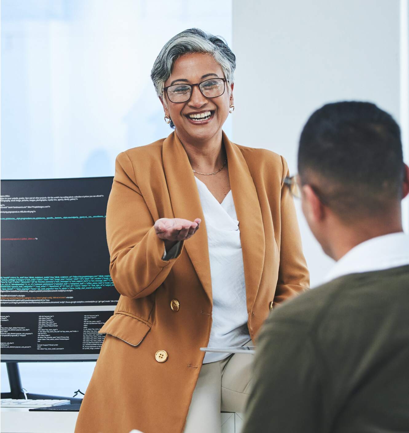 hr recruiter smiling and looking up from her laptop