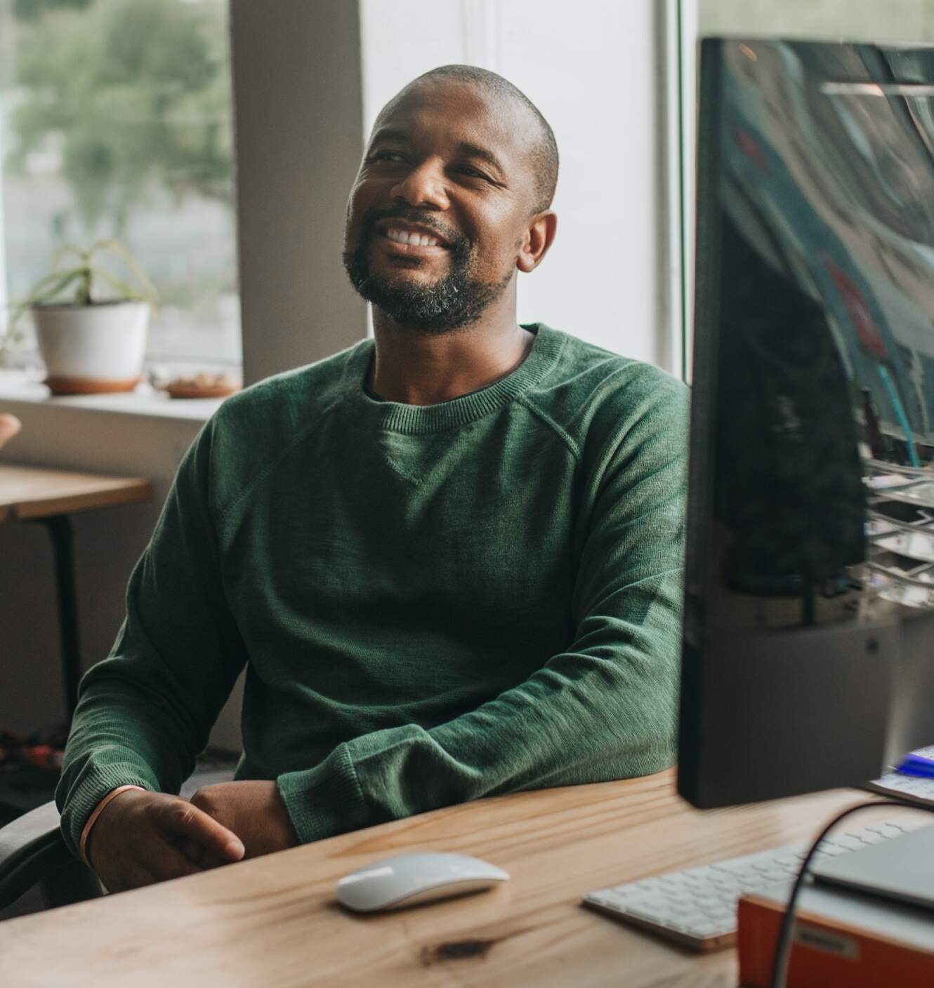 hr recruiter smiling and looking up from her laptop