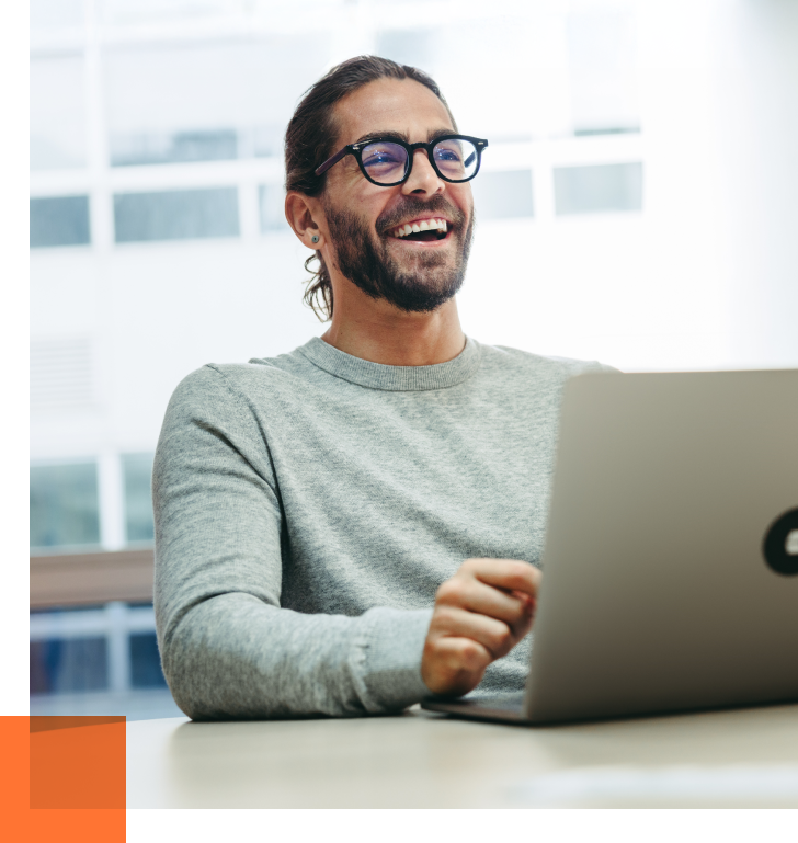 male hr recruitment firm employee smiling at laptop