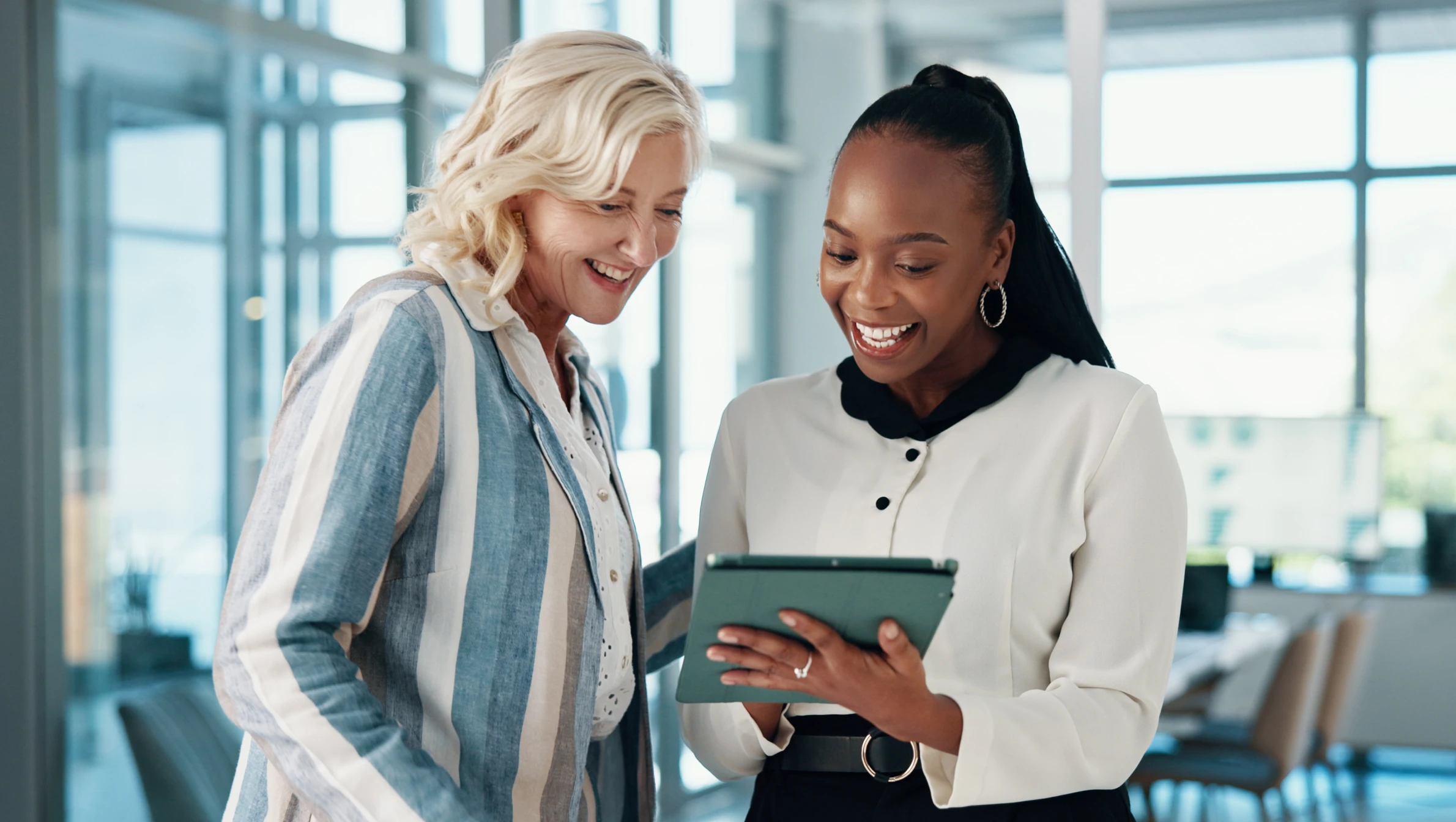 hr recruitment professionals standing looking at ipad in office