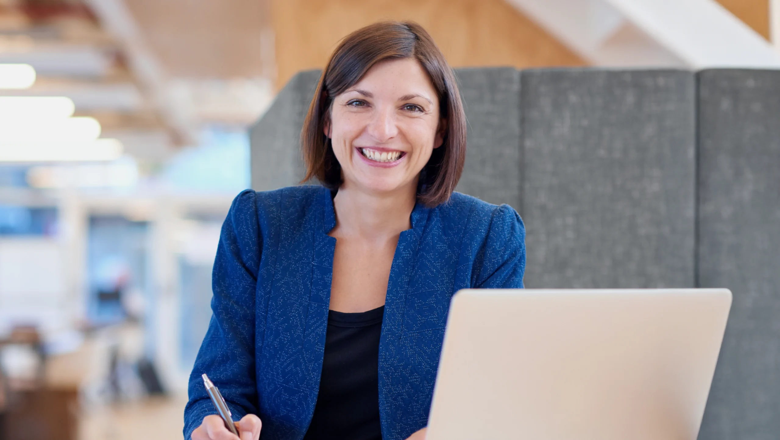 Female professional smiling with laptop
