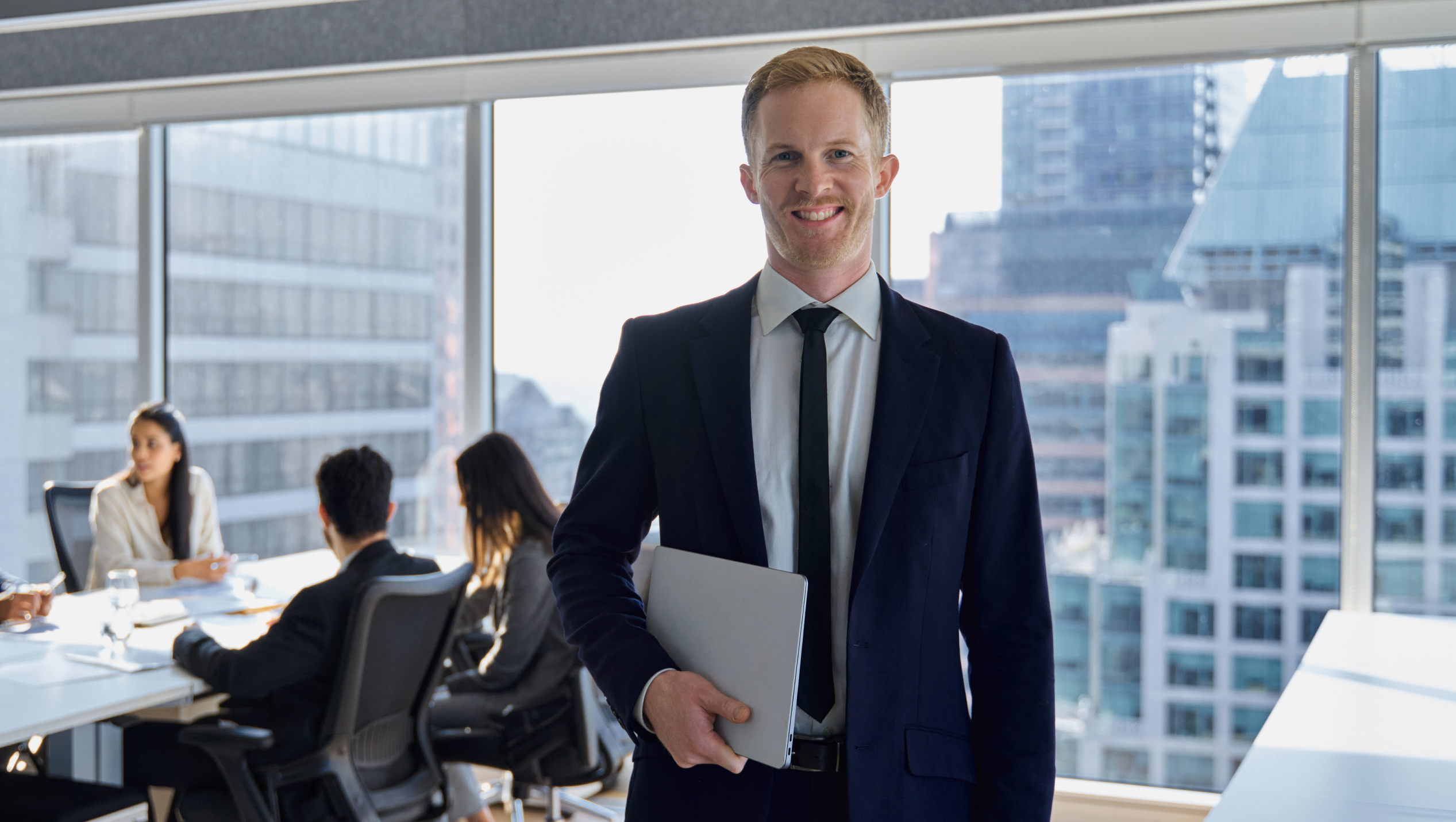 Male Professional holding laptop
