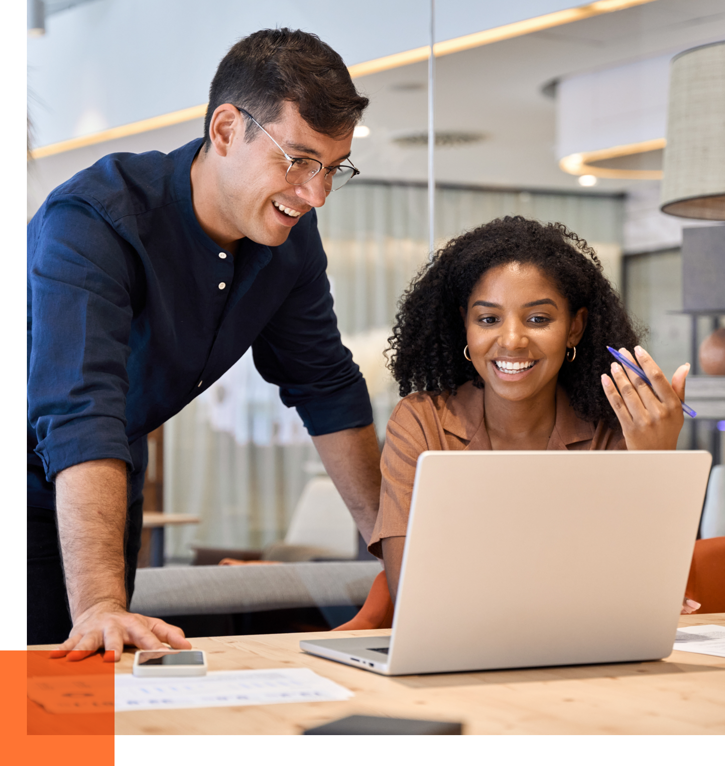 male and female consultants looking at laptop