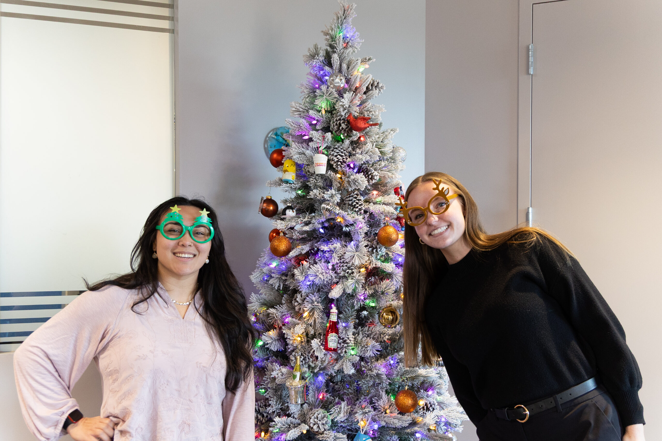 Female SSG employees decorating by Christmas tree