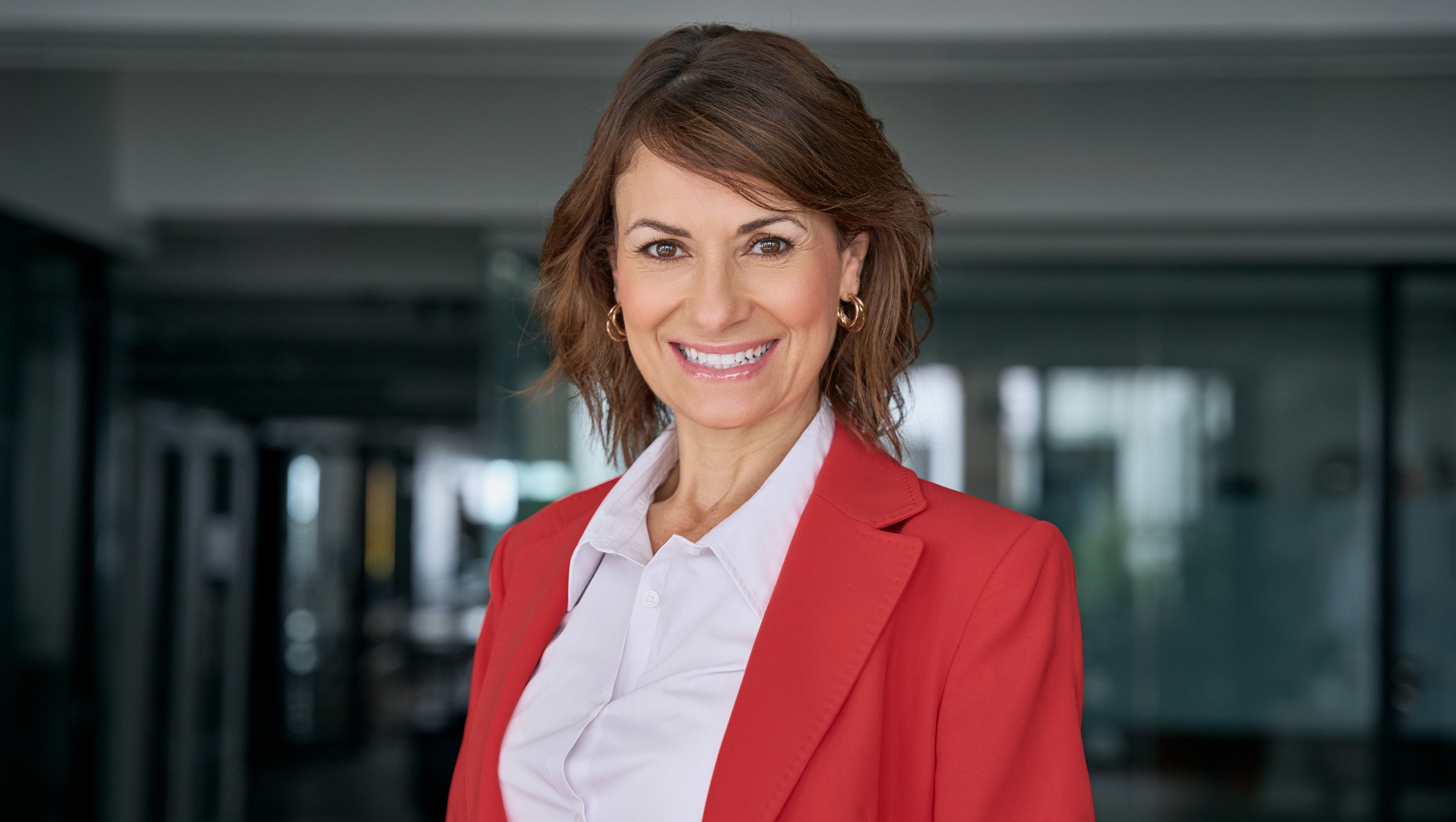 female CCO in red blazer